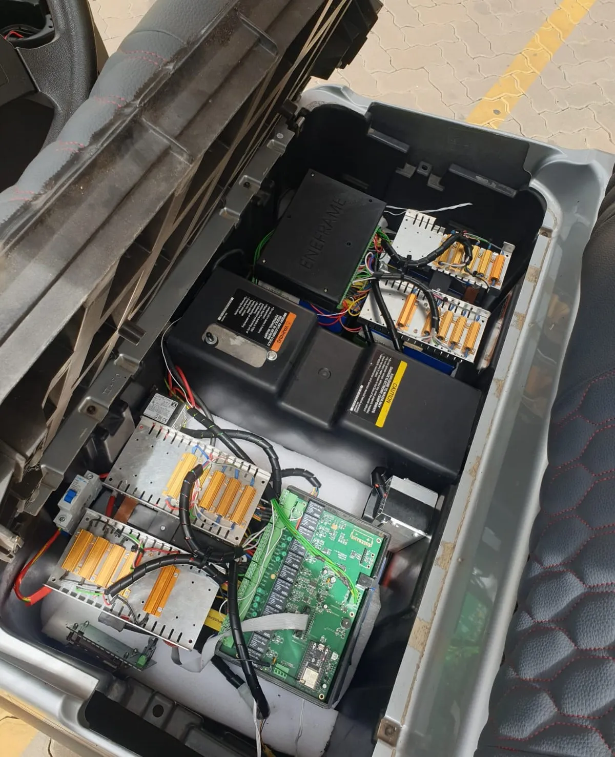 Lithium cells and battery management electronics installed beneath a golf cart seat
